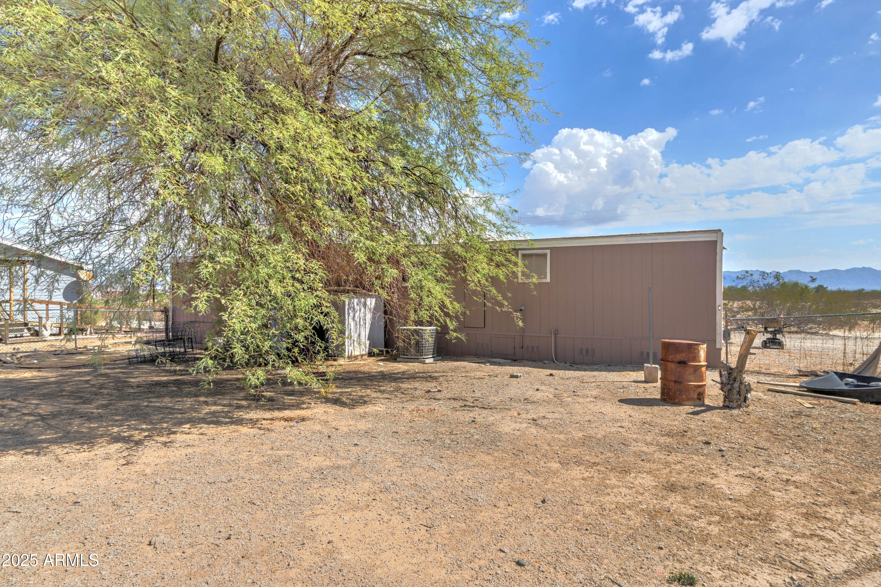 23402 South Manzanilla Road Buckeye, AZ 85326 - Photo 39 of 46 a backyard of a house with table and chairs