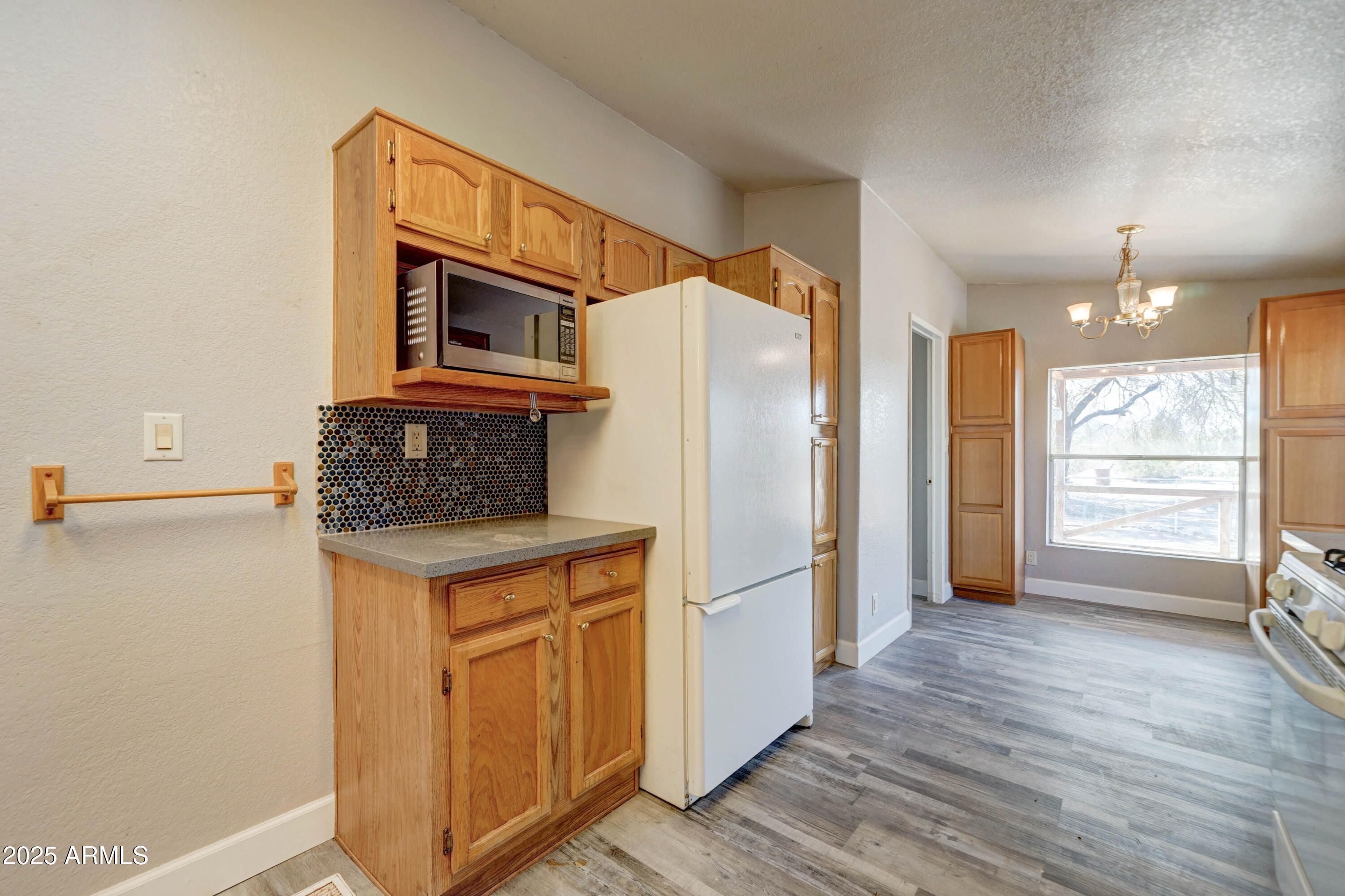 23402 South Manzanilla Road Buckeye, AZ 85326 - Photo 10 of 46 a kitchen with stainless steel appliances a refrigerator and a stove top oven