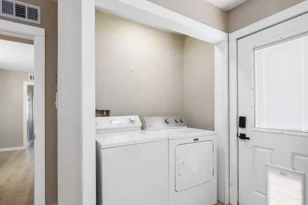 an empty room with a window and a ceiling fan