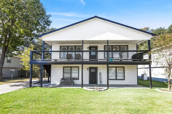 a view of a porch with furniture and a gate