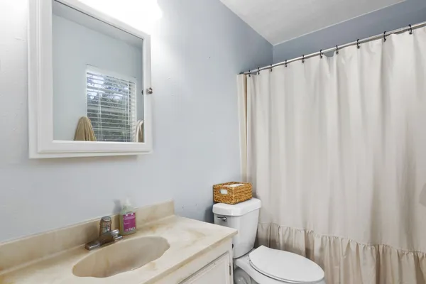 a bedroom with furniture and a window