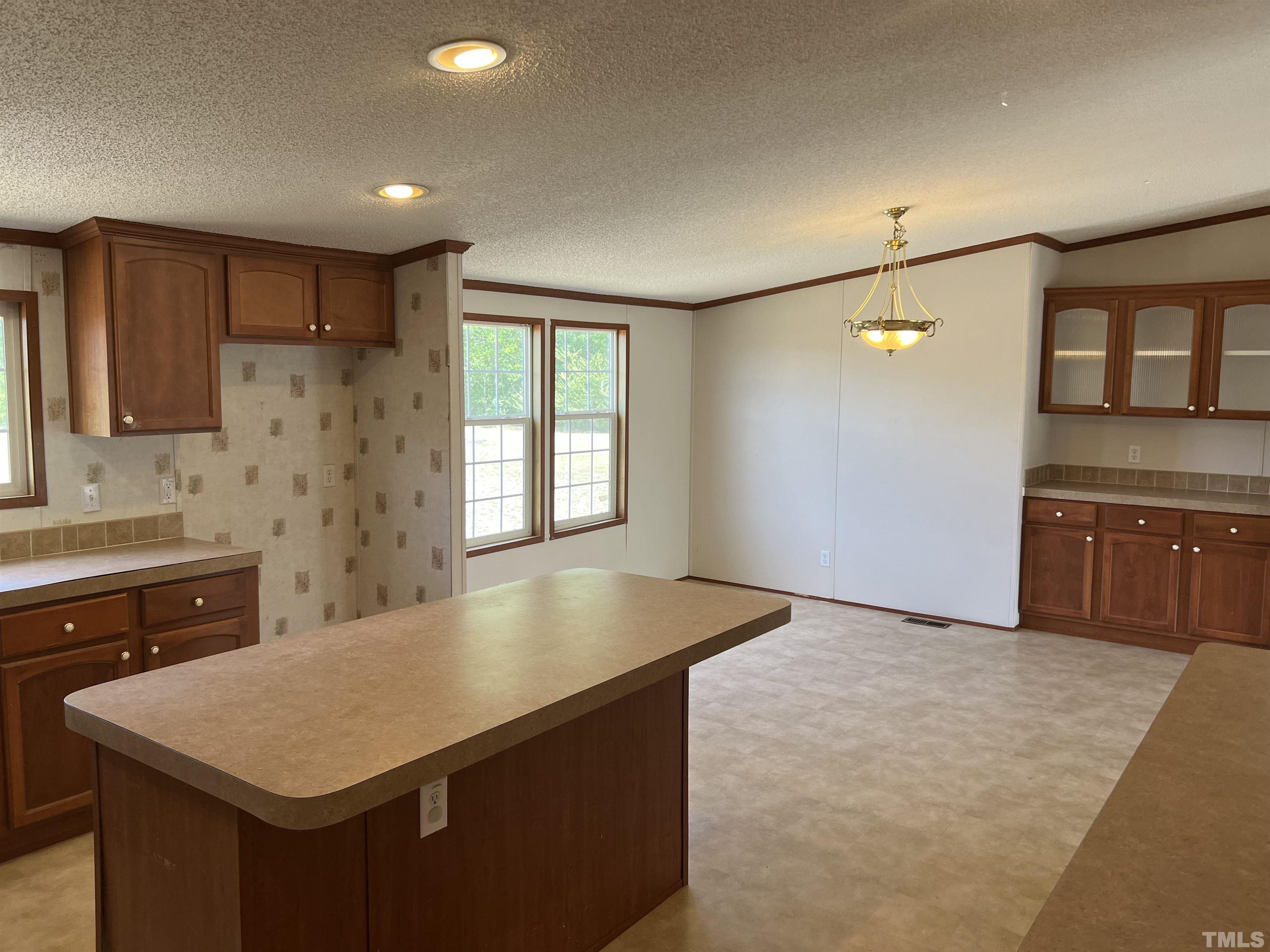 641 Rockinghorse Court Stedman, NC 28391 - Photo 21 of 50 a kitchen with kitchen island a sink stove and refrigerator