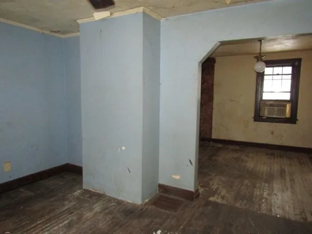 a view of a small space with wooden floor and a window