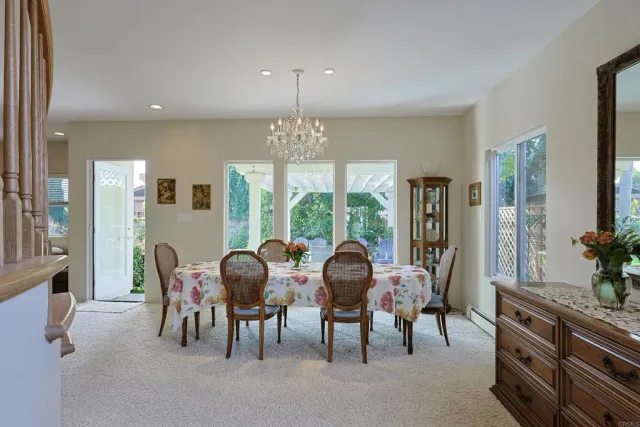 a living room with furniture and a view of kitchen