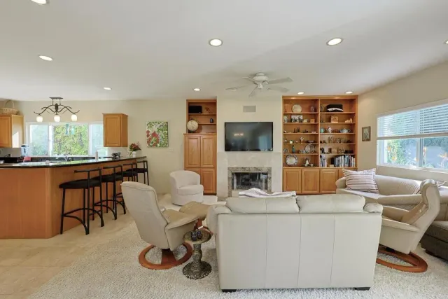 a kitchen with kitchen island granite countertop a sink a counter top space cabinets and stainless steel appliances