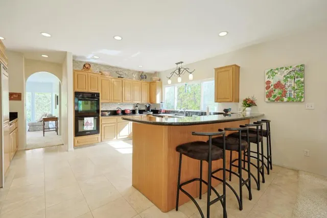 a bedroom with two beds and a large window