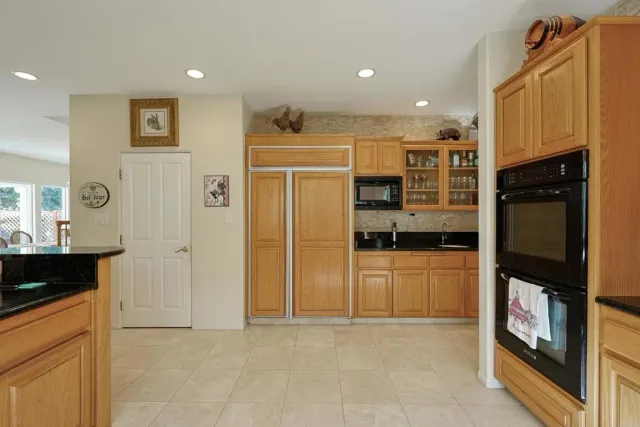 a bedroom with a bed and dresser with mirror