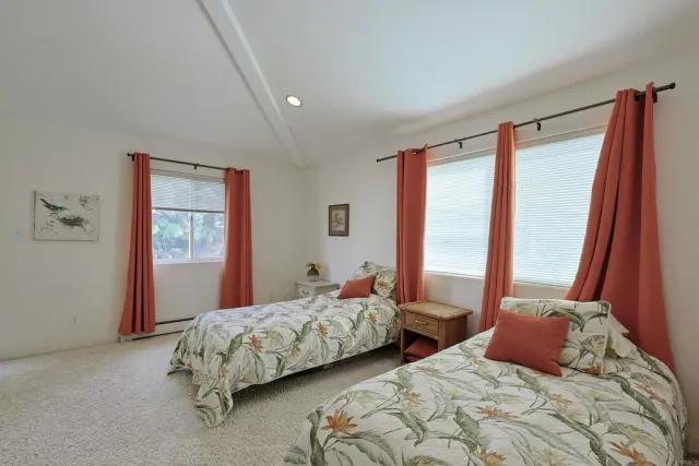 a spacious bedroom with a bed and furniture