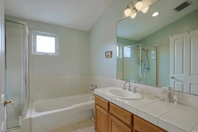 a bathroom with a tub sink and mirror