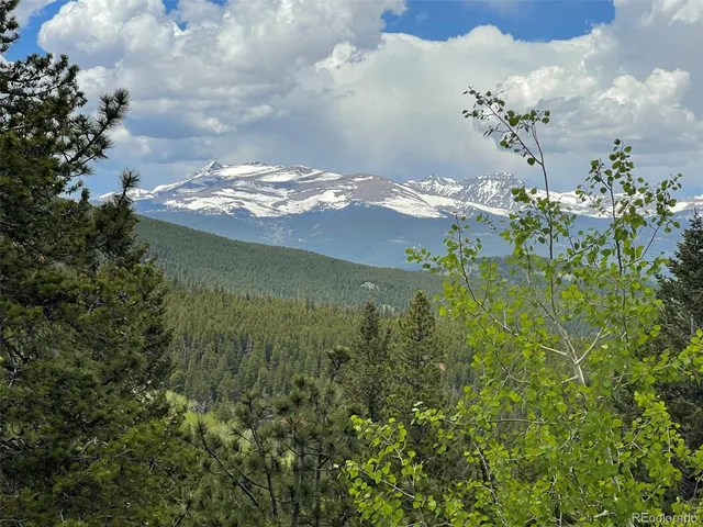 a bathroom with a granite countertop sink and a washing machine