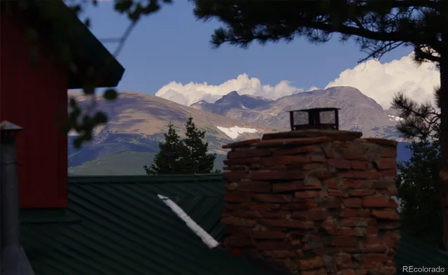 an outdoor view of house with deck and outdoor seating