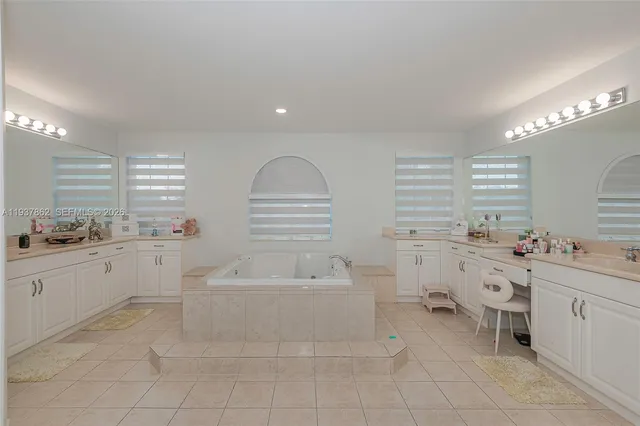 a large white room with a lot of white cabinets