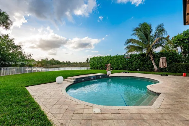 a view of a swimming pool with a patio
