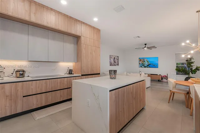 a view of living room with granite countertop furniture and flat screen tv
