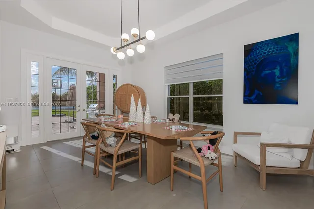 a view of a dining room with furniture and a chandelier fan