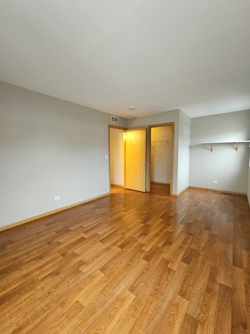 1530 Glacier Trail Carpentersville, IL 60110 - Photo 13 of 24 a view of empty room with wooden floor and fan