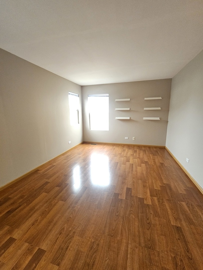 1530 Glacier Trail Carpentersville, IL 60110 - Photo 14 of 24 a view of empty room with wooden floor and fan