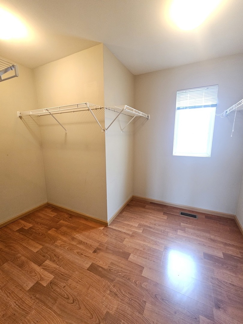 1530 Glacier Trail Carpentersville, IL 60110 - Photo 20 of 24 an empty room with wooden floor and windows