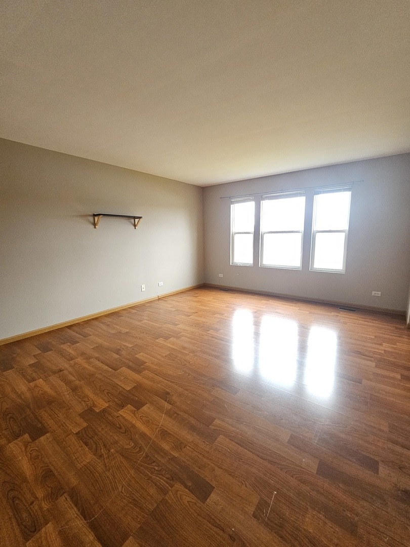 1530 Glacier Trail Carpentersville, IL 60110 - Photo 21 of 24 an empty room with wooden floor and windows