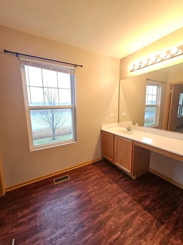 a bathroom with a double vanity sink mirror and window