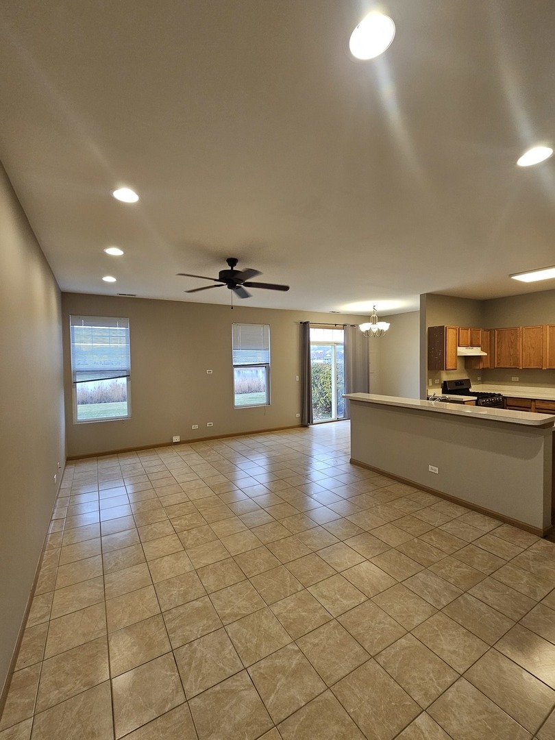 1530 Glacier Trail Carpentersville, IL 60110 - Photo 3 of 24 a view of an empty room and a kitchen with a sink