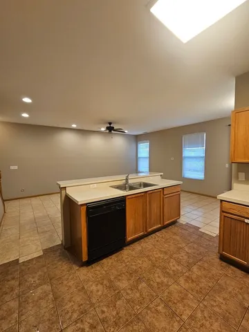 a kitchen with stainless steel appliances a stove a sink and a refrigerator