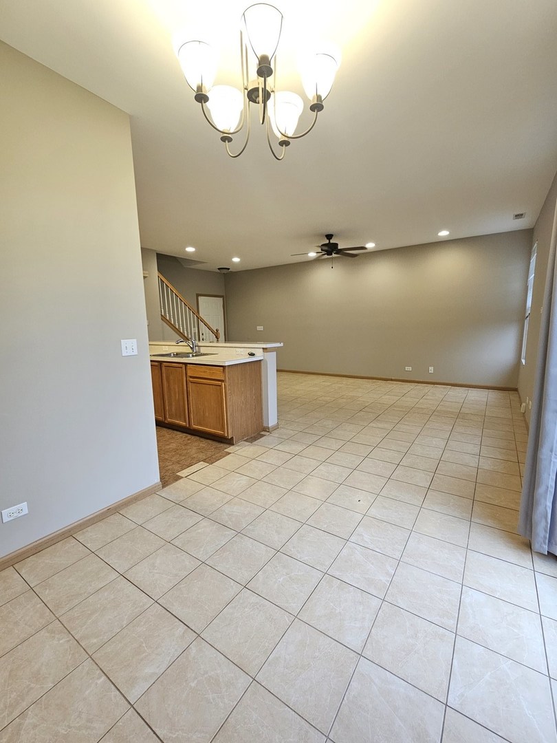 1530 Glacier Trail Carpentersville, IL 60110 - Photo 9 of 24 a view of a room with a projector and fan
