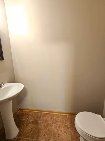 a bathroom with a toilet a sink and a mirror