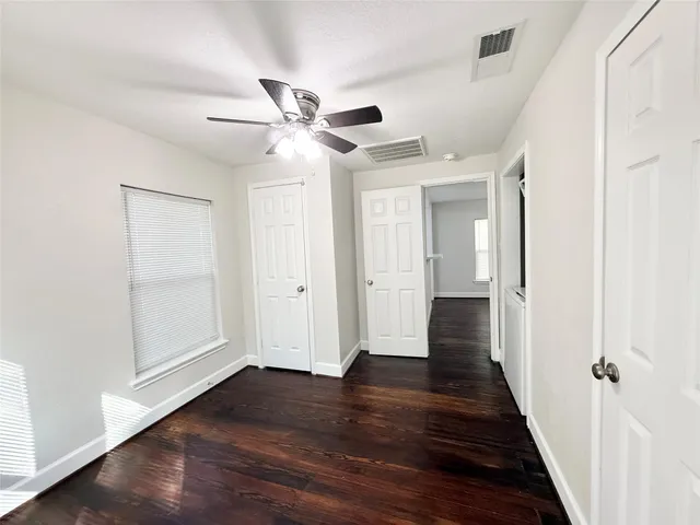 a view of a hallway with wooden floor
