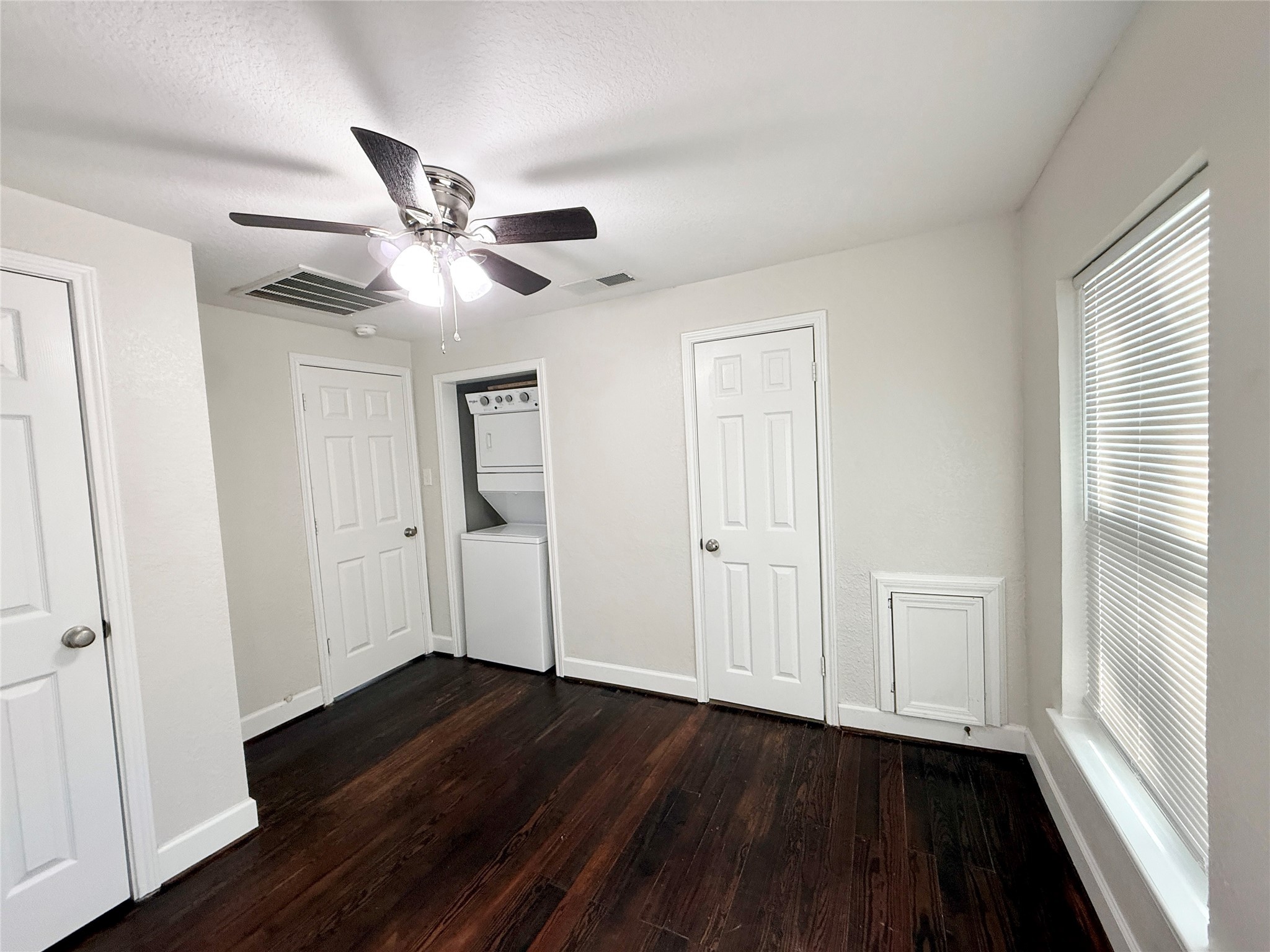 620 East Magnolia Street Angleton, TX 77515 - Photo 13 of 20 a view of empty room with wooden floor and fan
