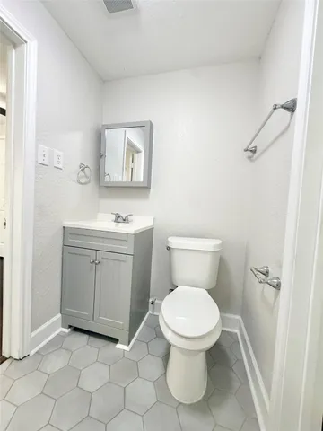 a white toilet sitting next to a bathroom sink