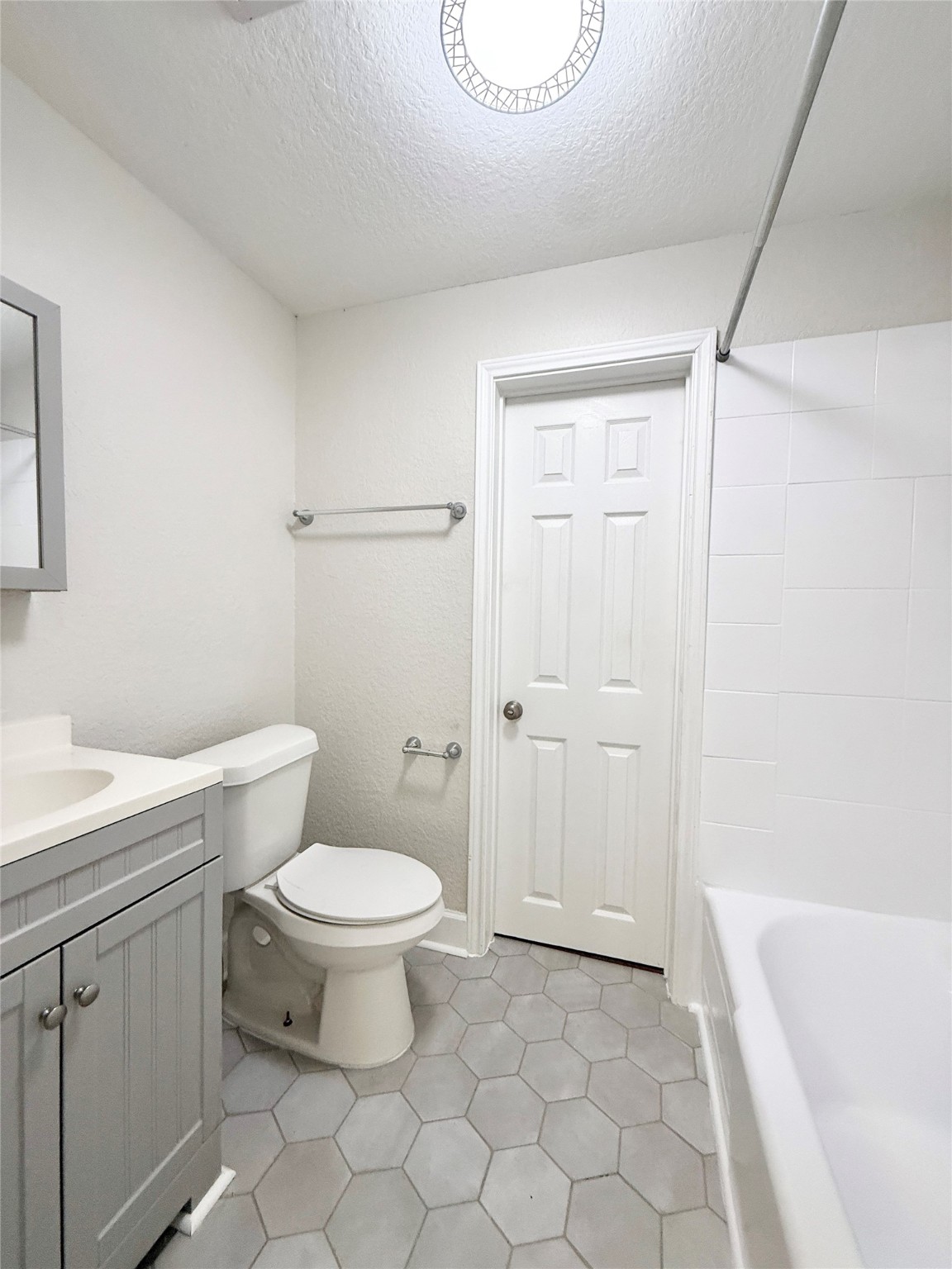 620 East Magnolia Street Angleton, TX 77515 - Photo 17 of 20 a bathroom with a toilet a sink a mirror and bathtub