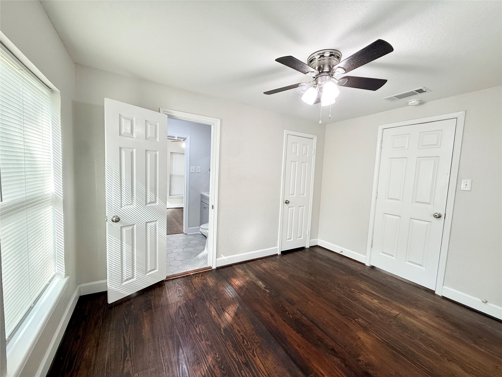 620 East Magnolia Street Angleton, TX 77515 - Photo 19 of 20 a view of an empty room with wooden floor and a window
