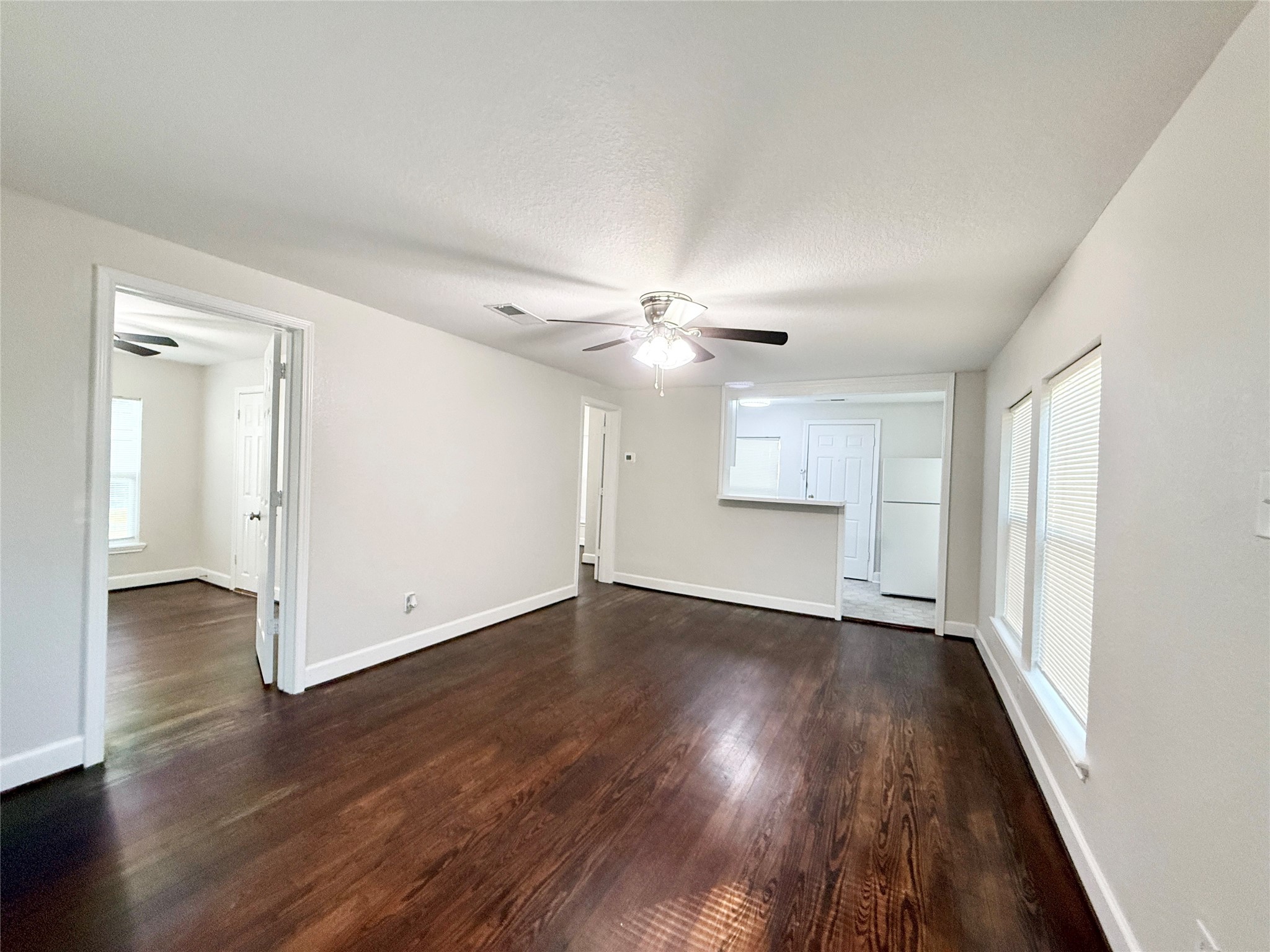 620 East Magnolia Street Angleton, TX 77515 - Photo 4 of 20 wooden floor in an empty room with a window