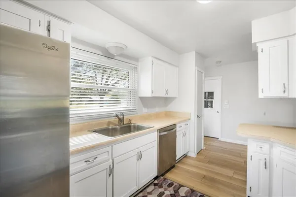 a kitchen with a sink stove and cabinets