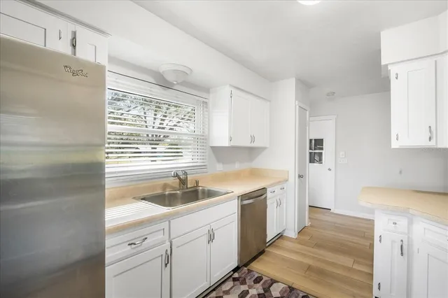 a kitchen with a sink stove and cabinets