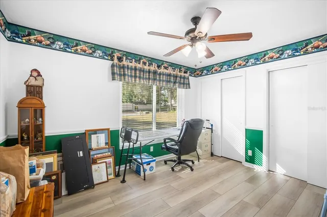 a view of a workspace with furniture and a window