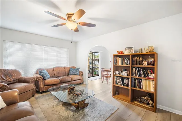 a living room with furniture and a book shelf