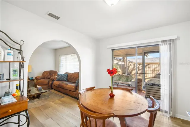 a living room with furniture a table and a chandelier