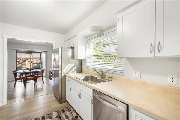a kitchen with a sink a stove and cabinets