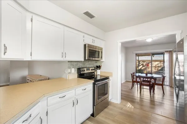 a kitchen with granite countertop appliances cabinets and furniture