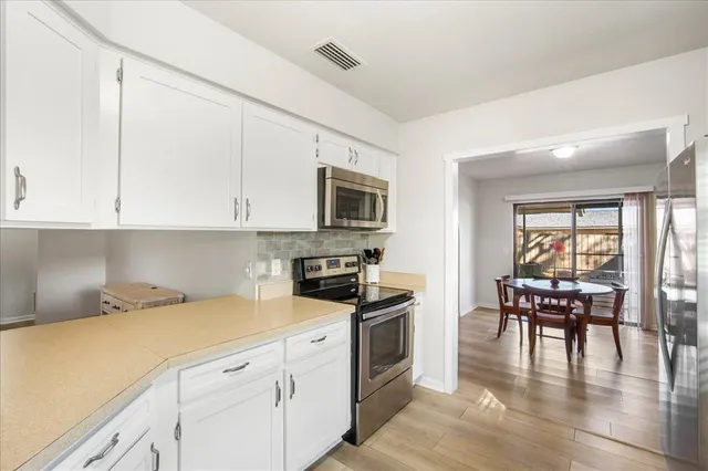a kitchen with granite countertop appliances cabinets and furniture