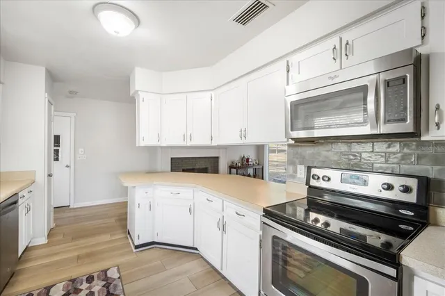 a kitchen with a stove microwave and cabinets