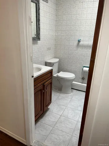 a bathroom with a toilet a sink a mirror and a shower