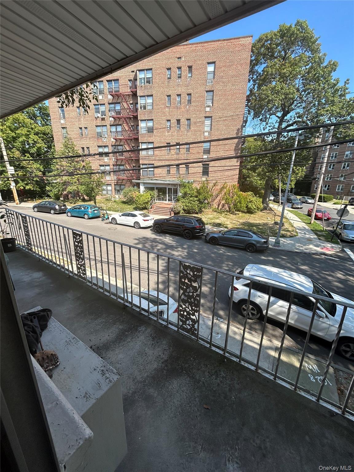 142-22 Pershing Crescent Queens, NY 11435 - Photo 2 of 11 a view of a porch with furniture and wooden fence