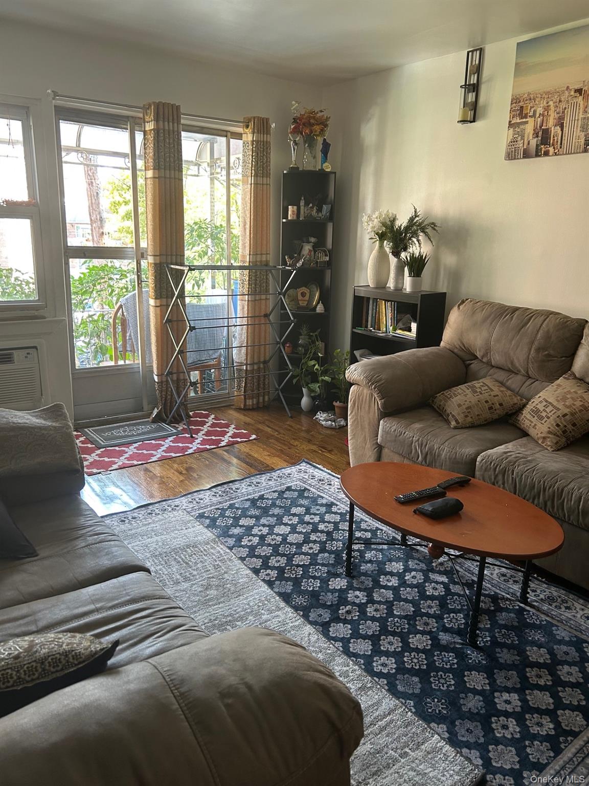 142-22 Pershing Crescent Queens, NY 11435 - Photo 3 of 11 a living room with a couch and a table