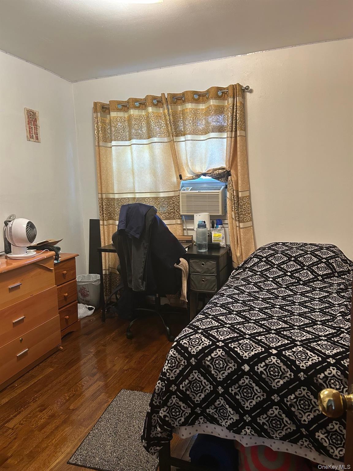 142-22 Pershing Crescent Queens, NY 11435 - Photo 5 of 11 a bedroom with a bed and wooden floor