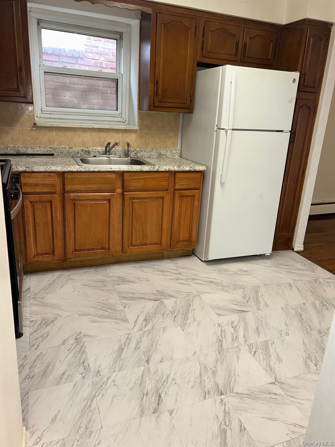 142-22 Pershing Crescent Queens, NY 11435 - Photo 10 of 11 a view of a kitchen with a sink
