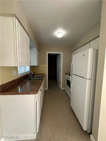 a kitchen with a refrigerator a sink and dishwasher