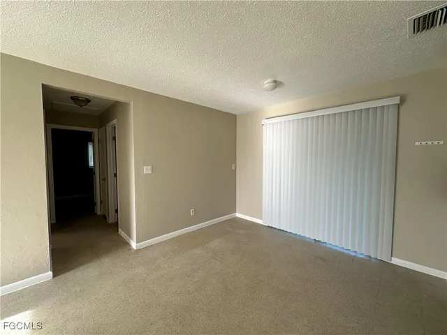 a view of an empty room and closet area